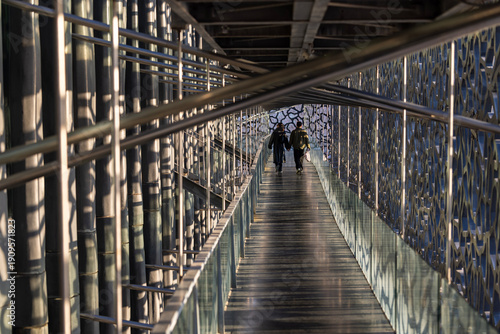 couple walk through the long walkway in france, marsellie