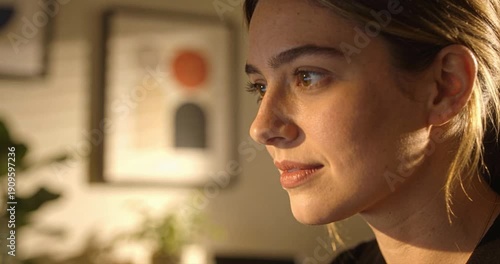 Woman portrait with soft sunlight and abstract art in interior