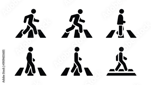 Black silhouettes of pedestrians crossing a street on a crosswalk