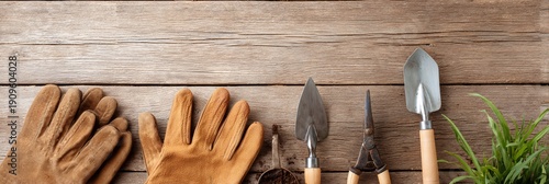 Pair of gardening gloves and a pair of pruning shears are on a wooden table