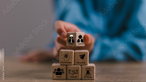 Tableau sur toile business hand man put arranging on wooden cube block that family or company Succession business concept from old generation to next generation