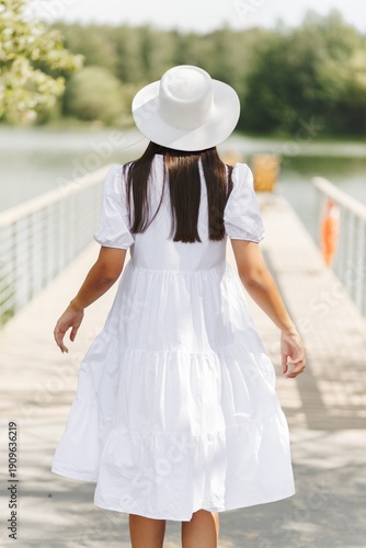 Wallpaper Mural Woman Walking On Bridge In White Dress. Summer Fashion And Serene Lake View. Torontodigital.ca