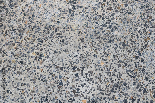 Konstfotografi A detailed view of an exposed aggregate concrete floor, showcasing a rich variety of natural stones and pebbles