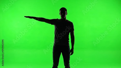 Wallpaper Mural A silhouetted person with an arm outstretched against a bright green background Torontodigital.ca