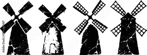four vintage windmills standing in a row with large sails and sturdy bases