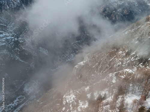 Wallpaper Mural clouds coming in Chamois alpine village aerial view in winter season Torontodigital.ca