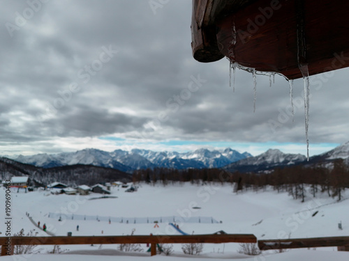 Wallpaper Mural icicles on wooden hut roof in Chamois alpine village aerial view in winter season Torontodigital.ca