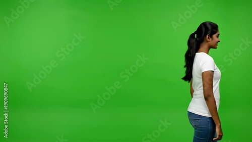 Wallpaper Mural A woman in white top and jeans poses against a bright green backdrop Torontodigital.ca