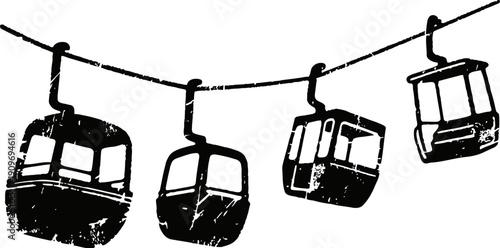 Cable car gondolas suspended on wire against sky silhouette urban transportation system