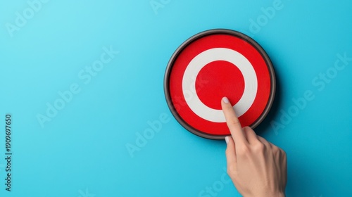 Wallpaper Mural A hand presses a red target button against a blue background, symbolizing focus, decision-making, or activation. Torontodigital.ca