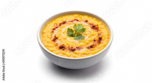 Delicious corn pudding in a white bowl garnished with herbs