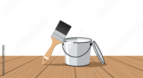 Open white paint bucket with brush, positioned on a brown wooden floor against a simple white wall.