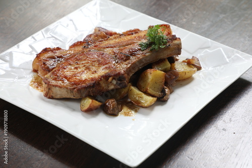 Obraz na plátně Côte de porc servie avec pommes de terre au restaurant