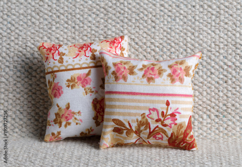 Vintage cushion with rose on sofa