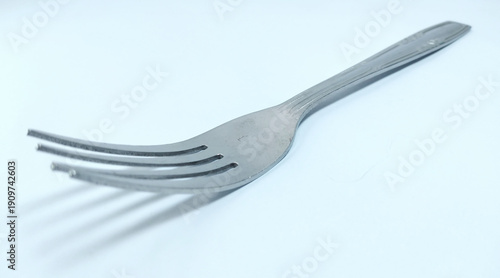 Shiny metal fork utensil isolated on background