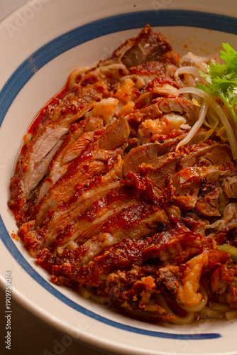 Seared pork on spicy noodle bowls. Slices of pork over fiery noodles with sprouts. Barbecued pork slices arranged over steaming spicy noodles complemented with fresh sprouts and seasonings