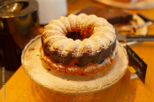 Soft crumbed cake with glaze presentation. Rustic homemade bundt with subtle glaze for serving. Homestyle bundt cake with sugar dusting and rustic presentation suitable for gatherings
