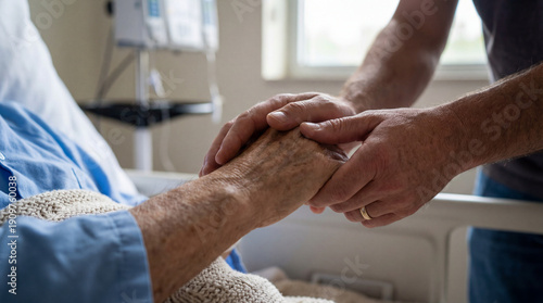 Wallpaper Mural A man gently holds an elderly patient's hand in a hospital. Torontodigital.ca