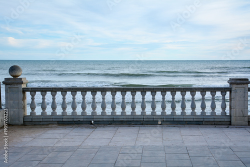 Mediterranean sea view from stone balustrade promenade, tranquil coastal scene with waves and horizon ideal for travel, tourism and relaxation concepts