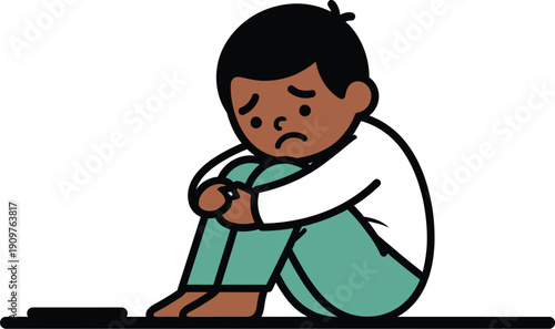 Sad young boy sits hugging knees while displaying feelings of loneliness and depression against a white background.