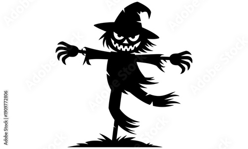 spooky halloween scarecrow with pumpkin face and witch hat standing on grass