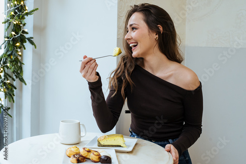 Woman enjoys dessert and dr...