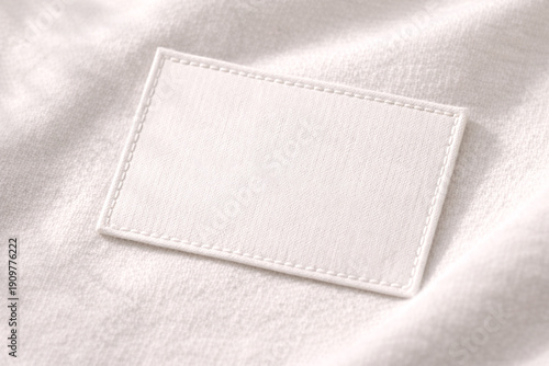 A close-up of a sewn-on brand tag on high-quality natural fabric. An exquisite textile detail, ideal for fashion branding and presenting high-quality textiles.