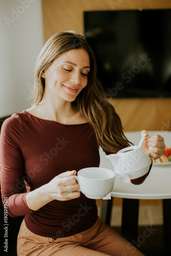Woman enjoying tea in a coz...