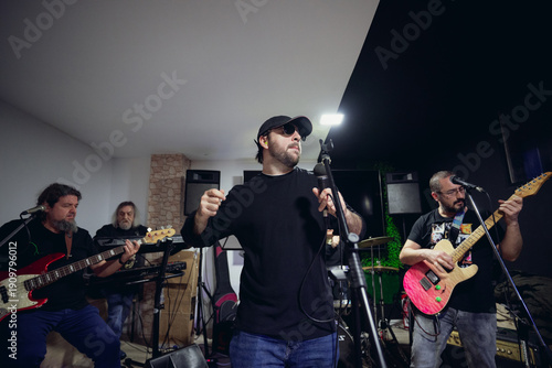 Photos Music band rehearsing song performance in studio