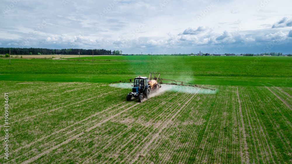 Fototapeta premium Aerial view, Tractor spraying pesticides at soy bean fields