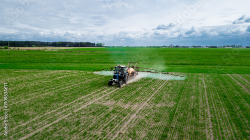 Photos Aerial view, Tractor spraying pesticides at soy bean fields