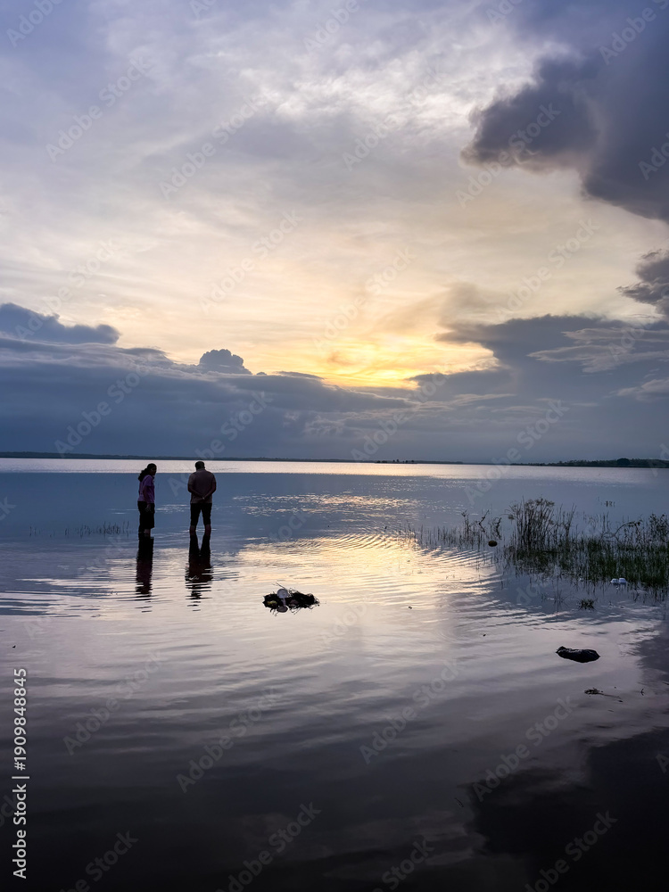 Fototapeta premium Two couple chilling on river side at the time sunset.