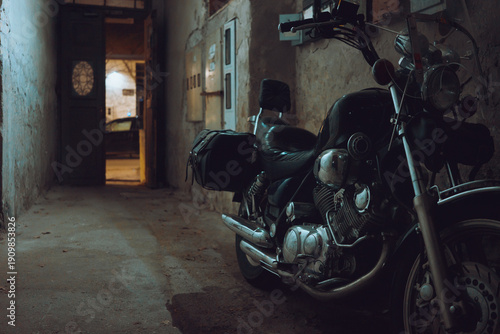 A large motor parked in the passage of an old building