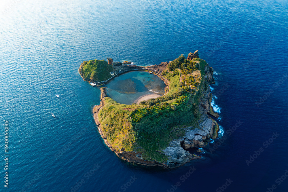 Fototapeta premium Aerial drone shot rocky volcanic island with crater lake in front of the Sao Miguel island, Azores