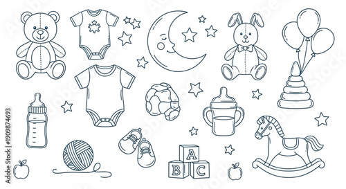 Collection of baby items including toys and clothing arranged with stars and moon