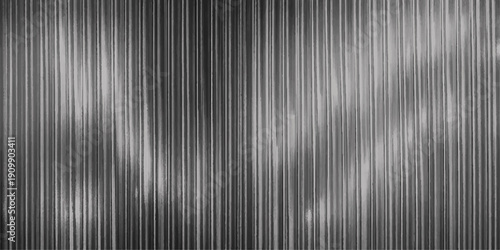 A dark gray brushed metal texture background features a sleek silver steel surface design with horizontal metallic lines and a striped aluminum pattern for a modern industrial wallpaper backdrop