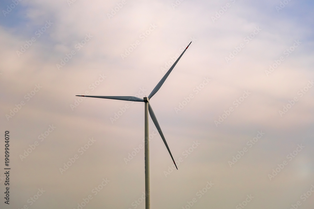 Fototapeta premium a wind turbine, a structure that converts wind energy into electrical energy with rainbow cloudy sky
