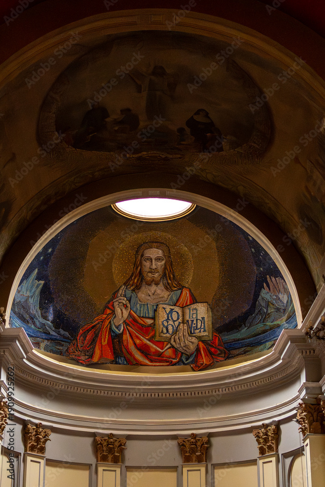 Obraz premium Neoclassical Church Architecture with Ornate Columns and Religious Fresco, Vertical Perspective of Traditional Christian Basilica