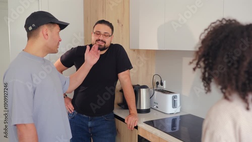 Wallpaper Mural Professional handyman talks with apartment tenants about kitchen cabinet issue. Indoor maintenance visit, property management service and home repair consultation scene. Torontodigital.ca