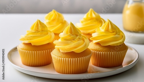 Wallpaper Mural delicious frosted cupcakes with yellow icing in bright yellow wrappers on a white plate perfect for a celebration or dessert Torontodigital.ca
