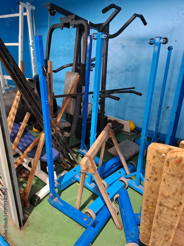 Fotografie Old sports equipment piled in the corner of a gym during a winter day