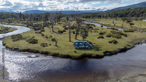 Modern overlanding lifestyle in remote nature. Drone shot of camper van embracing freedom, minimalism and connection with the outdoors.