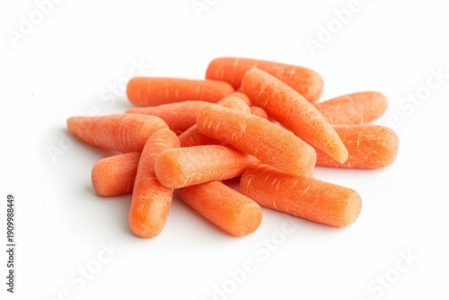 A small mound of peeled, bright orange baby carrots rests on a pure white backdrop, emphasizing their wholesome and ready-to-eat nature