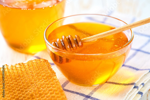 Wallpaper Mural Glass bowl with sweet honey and honeycombs on white table. Torontodigital.ca