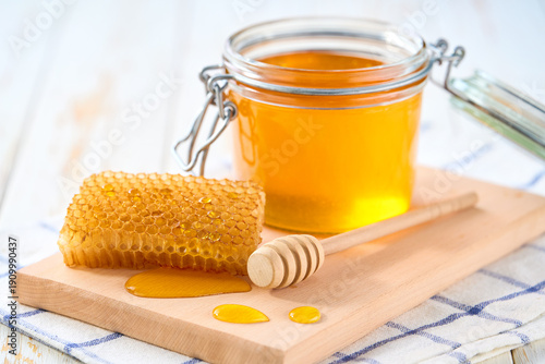 Wallpaper Mural jar of nature honey on light kitchen table, selective focus. Honey in a glass jar. Torontodigital.ca