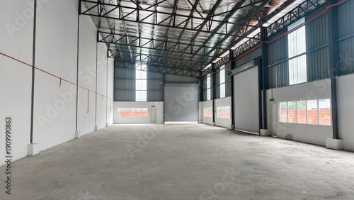 Tableau sur toile Interior view of a modern empty warehouse factory with concrete floor and high c