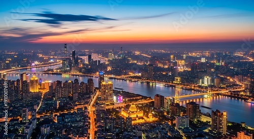 City skyline at dusk illuminated buildings and river at twilight
