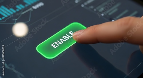 A close-up of a hand pressing a green enable button on a digital interface.