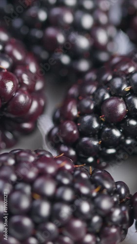 Detailed photograph of luscious blackberries highlighting texture, Studiolit macro photography capturing essence of ripe blackberries and their natural glossiness