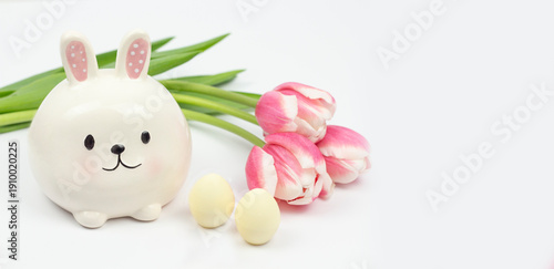 Cute Easter Bunny Figure with Eggs and Pink Tulips on White Background